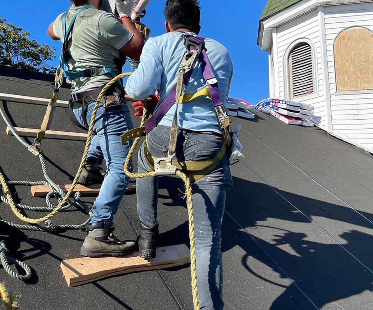 Roofing crew working on a roof deck